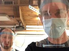 Peter Jansen and David Lesser wear the face shields they are helping create.