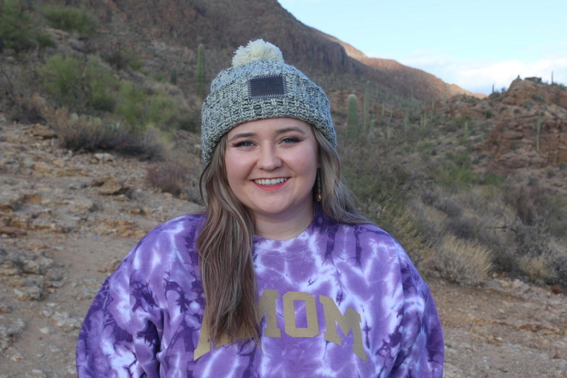 Caitlin Moffett standing outdoors in the Sonoran Desert